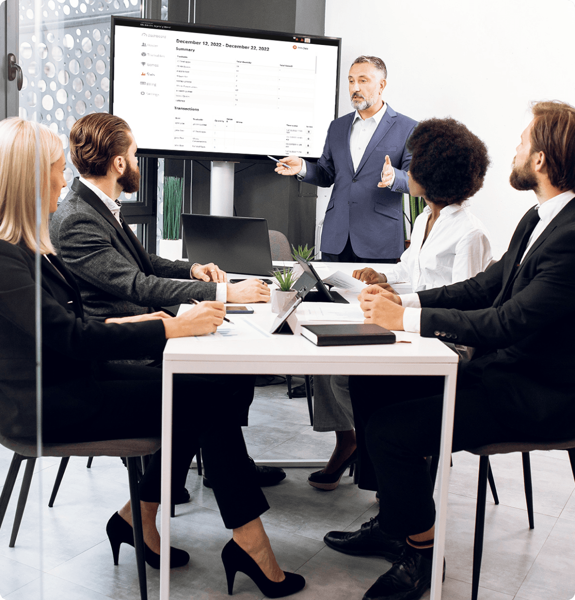 Sales team reviewing weekly results together using ScoreboardBuzz dashboards